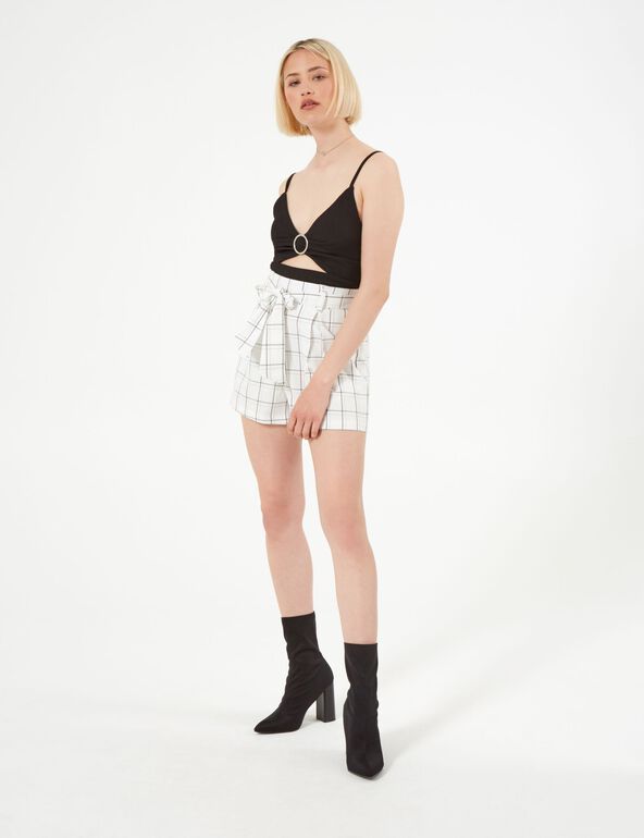 White and black checked shorts teen